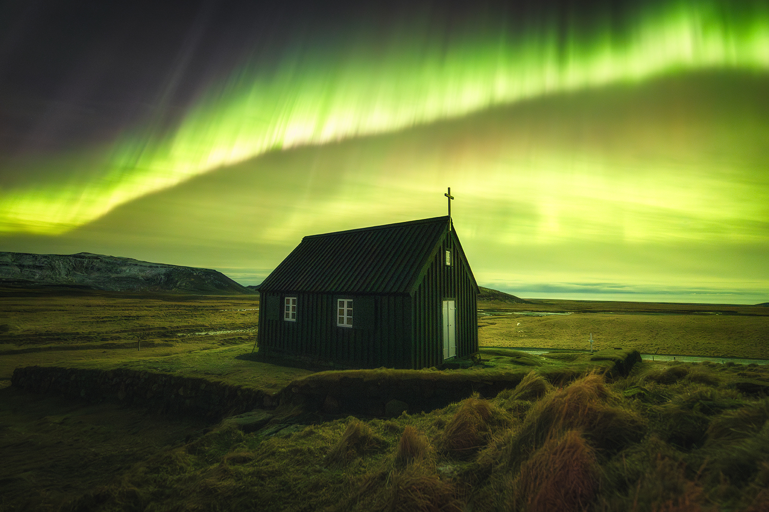 A powerful aurora over a small, traditional Icelandic church A powerful aurora over a small, traditional Icelandic church